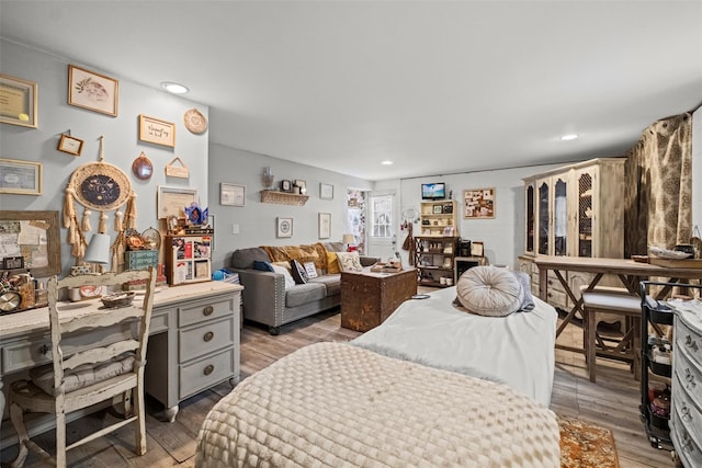 bedroom featuring recessed lighting and wood finished floors