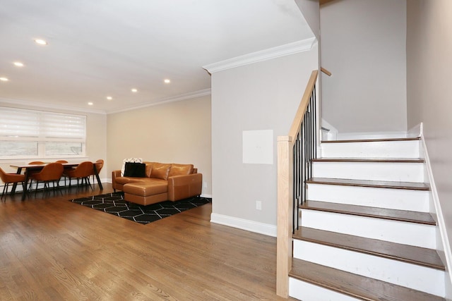 interior space featuring crown molding, recessed lighting, wood finished floors, baseboards, and stairs