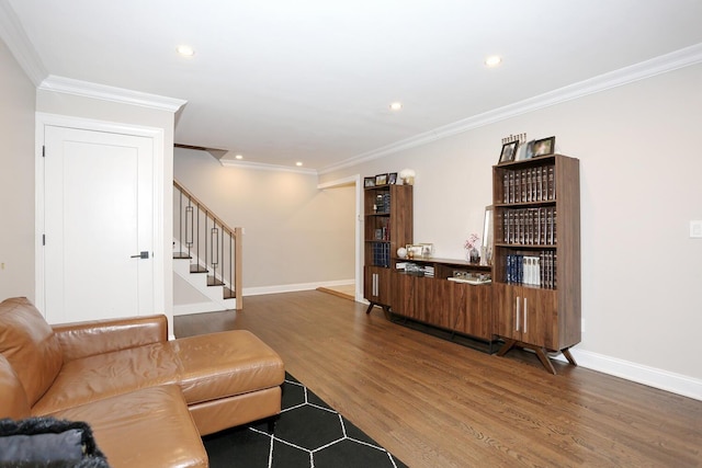 living room featuring recessed lighting, wood finished floors, baseboards, stairs, and ornamental molding