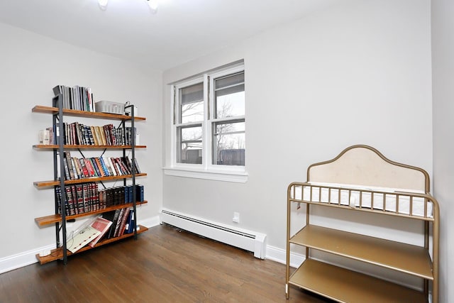 interior space with baseboards, baseboard heating, and wood finished floors