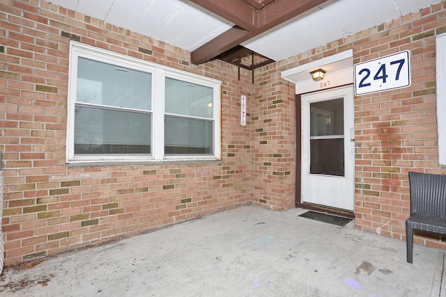 entrance to property with brick siding