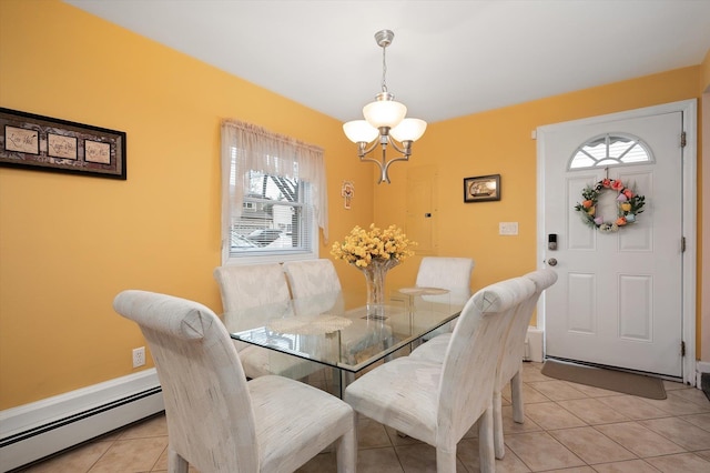 dining area with a chandelier, baseboard heating, and light tile patterned flooring