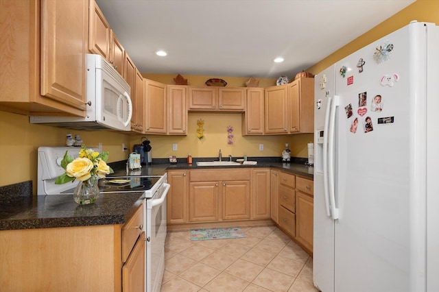 kitchen with light tile patterned floors, dark countertops, recessed lighting, a sink, and white appliances