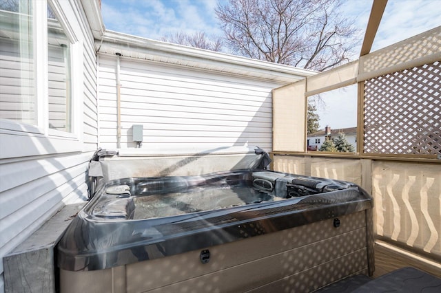 wooden deck featuring a hot tub