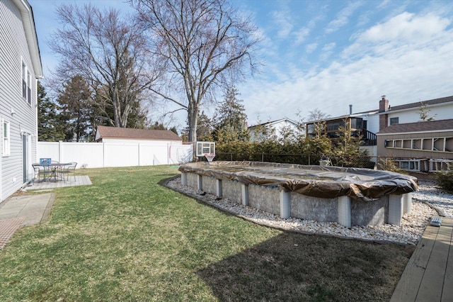 view of yard with a patio area, a fenced backyard, and a fenced in pool