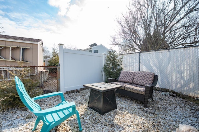 view of patio / terrace featuring an outdoor fire pit and a fenced backyard