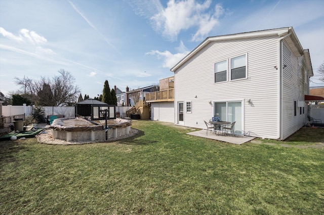 back of property featuring a fenced backyard, a lawn, and a patio