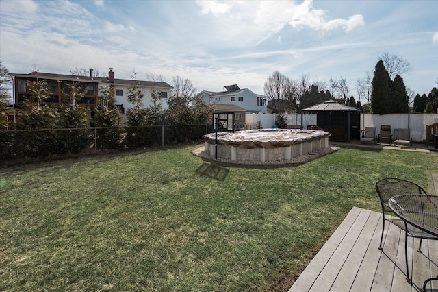 view of yard with a gazebo, an outdoor structure, a fenced backyard, and a fenced in pool