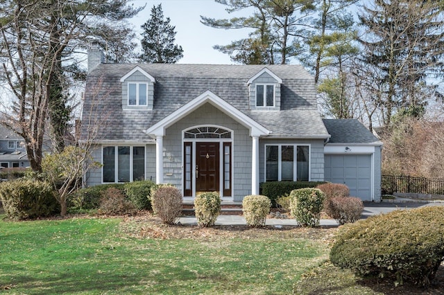 view of front of property with a garage, a front lawn, a chimney, and a shingled roof