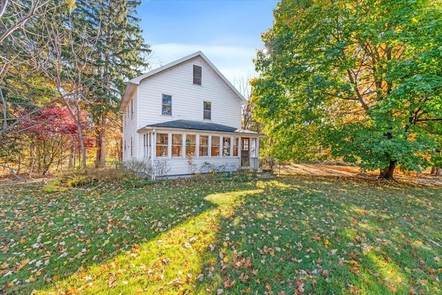 exterior space featuring a sunroom and a yard