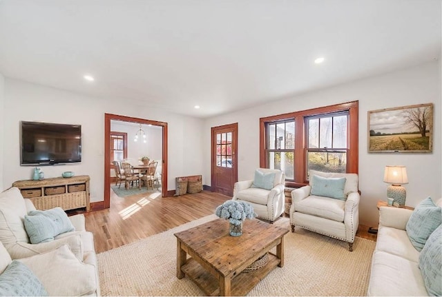 living room with recessed lighting, baseboards, and light wood finished floors