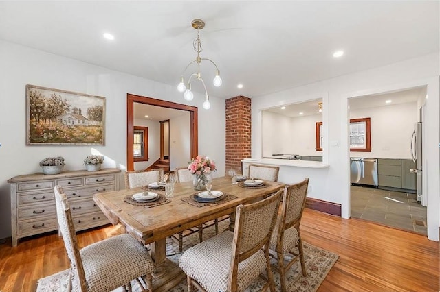 dining area with baseboards, light wood finished floors, and recessed lighting