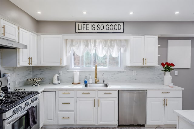 kitchen with white cabinetry, appliances with stainless steel finishes, light countertops, and a sink