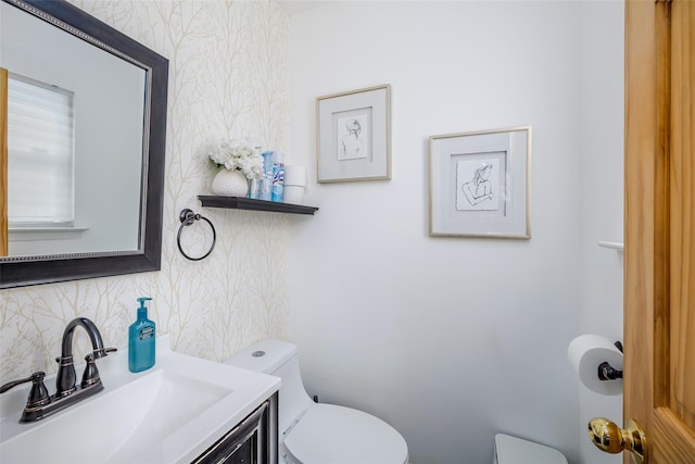 bathroom featuring tasteful backsplash, vanity, toilet, and wallpapered walls