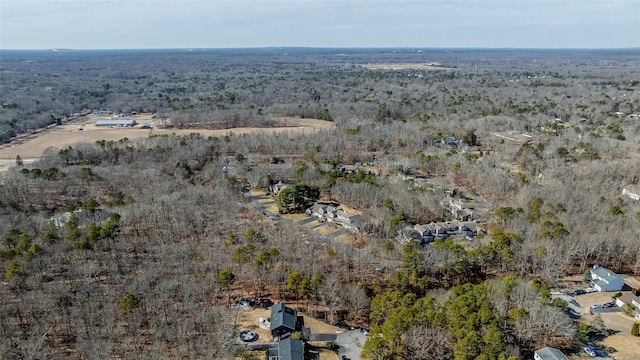 birds eye view of property with a forest view