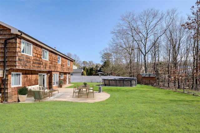 view of yard with a patio, outdoor lounge area, fence, and a fenced in pool