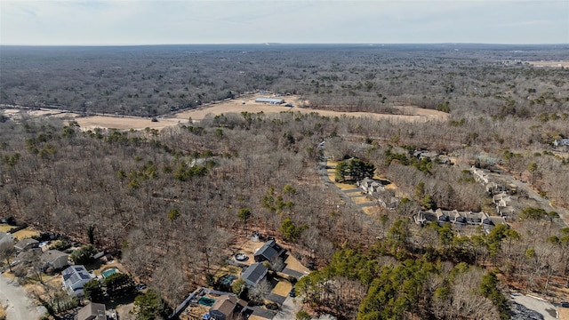 birds eye view of property featuring a view of trees