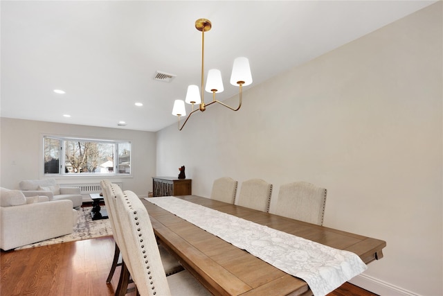 dining space featuring recessed lighting, visible vents, radiator heating unit, and wood finished floors