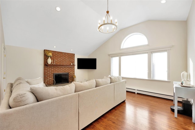 living room featuring recessed lighting, a baseboard heating unit, a brick fireplace, vaulted ceiling, and wood finished floors