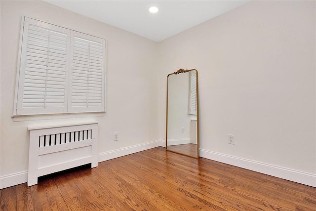 unfurnished bedroom with baseboards, wood finished floors, and recessed lighting