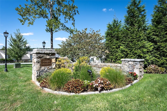 community sign featuring a lawn