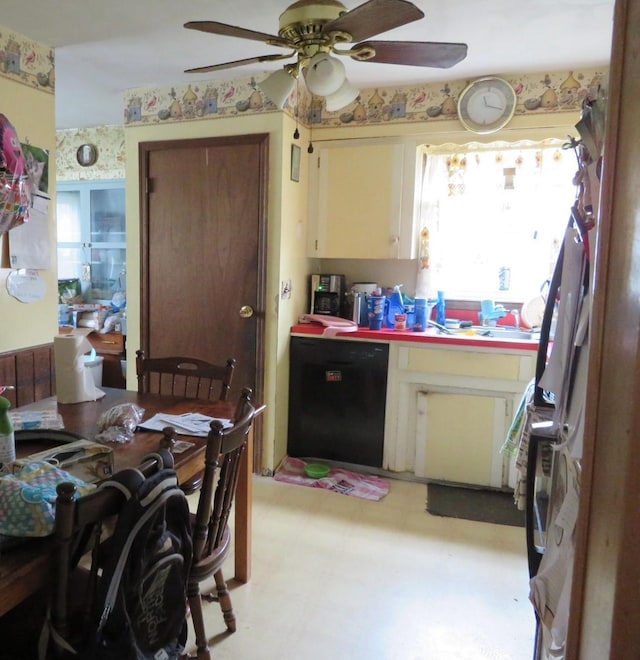 kitchen featuring black dishwasher, light floors, and a ceiling fan