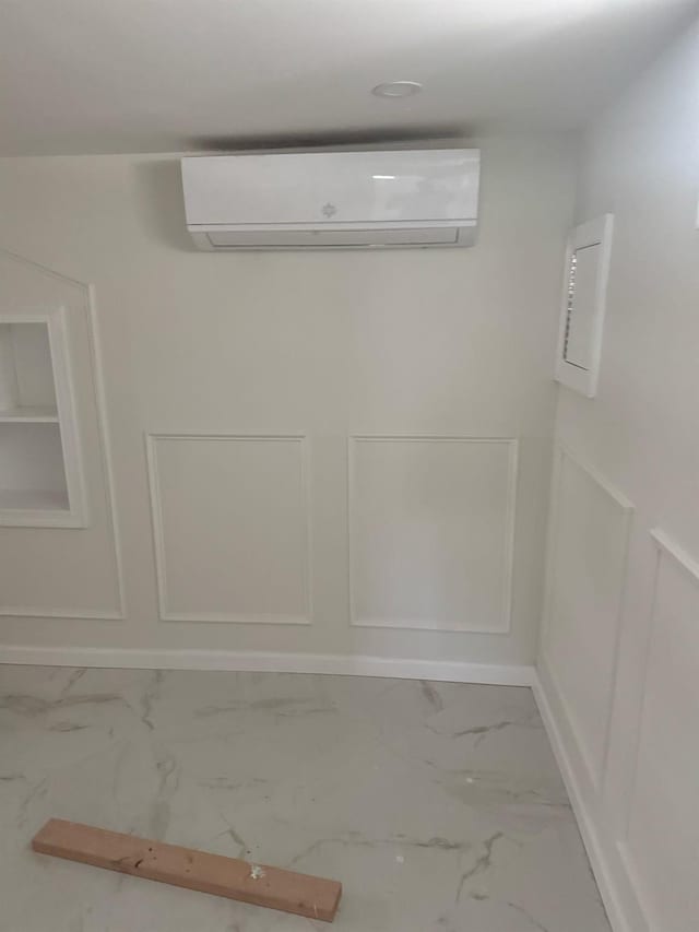 interior details with a wall mounted AC and baseboards