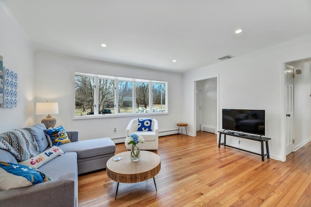 living room with crown molding, light wood-style flooring, visible vents, and baseboard heating