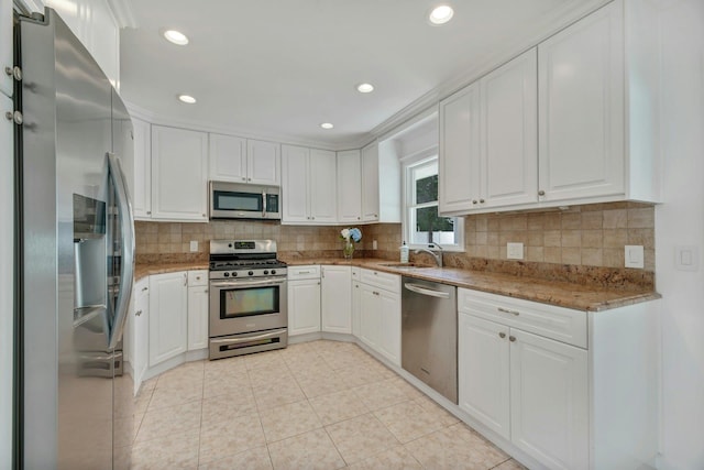 4645 Rocky Point Rd, East Marion, NY 11939 - kitchen featuring appliances with stainless steel finishes, a sink, white cabinets, decorative backsplash, and recessed lighting