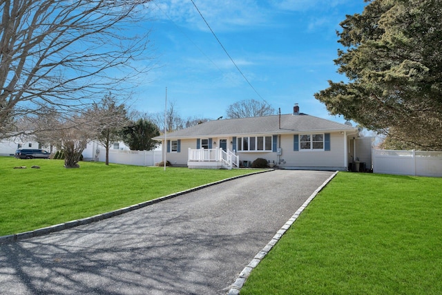 4645 Rocky Point Rd, East Marion, NY 11939 - ranch-style house featuring asphalt driveway, cooling unit, and a chimney
