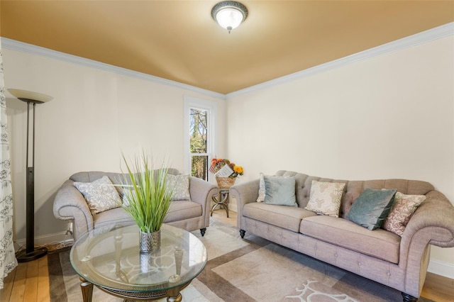 living room featuring ornamental molding, baseboards, and wood finished floors