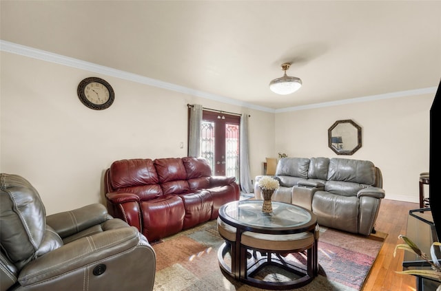 living room with baseboards, crown molding, and hardwood / wood-style floors