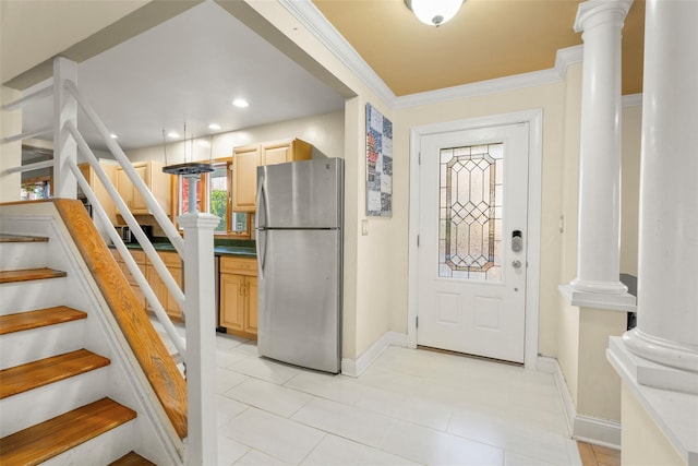 kitchen with ornamental molding, freestanding refrigerator, ornate columns, and light brown cabinetry