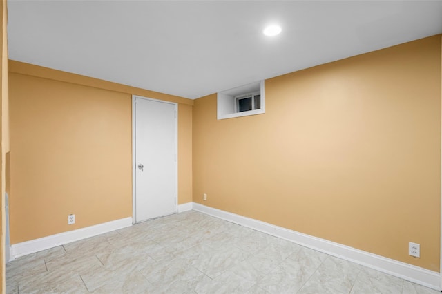 spare room with baseboards