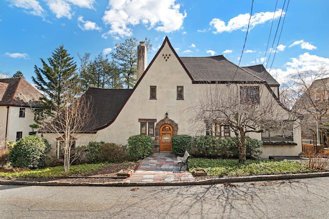 view of front of property with stucco siding and a shingled roof