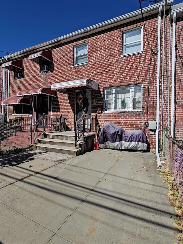 view of property featuring brick siding