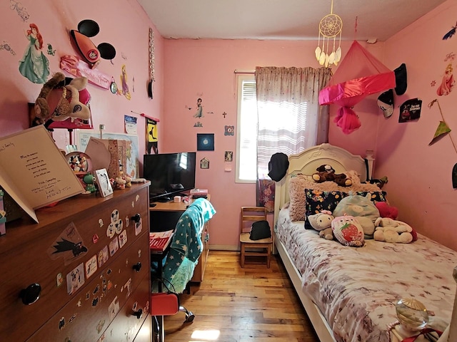 bedroom with wood finished floors