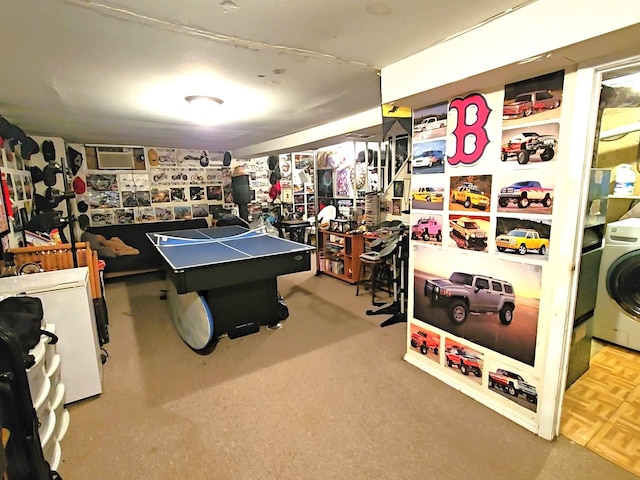 game room featuring a wall unit AC and washer / dryer