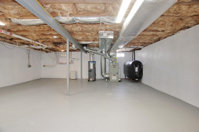 below grade area featuring heating unit, water heater, and heating fuel