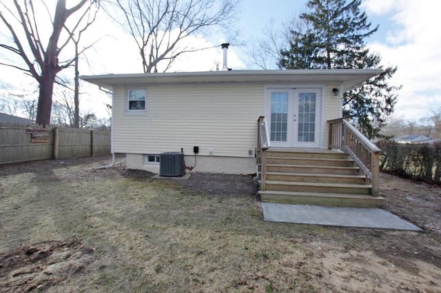 rear view of house featuring french doors, central AC, and fence