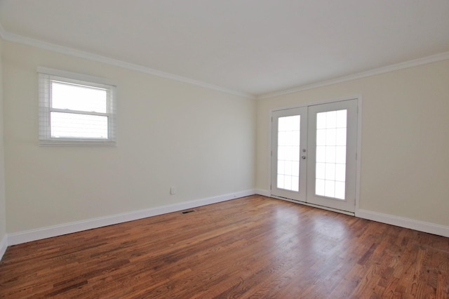 unfurnished room featuring baseboards, french doors, wood finished floors, and crown molding