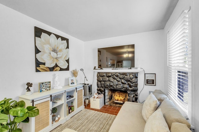 living room with a stone fireplace