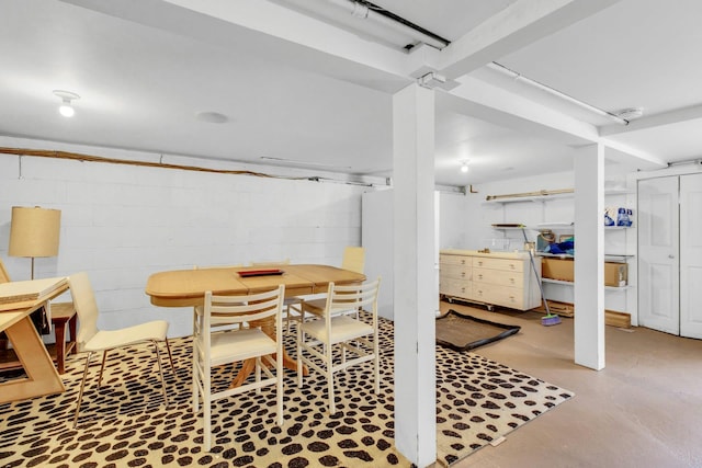 dining space with concrete block wall and concrete flooring