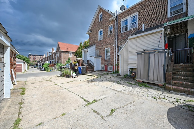 rear view of house with a residential view and brick siding