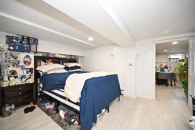 bedroom featuring a baseboard heating unit, recessed lighting, baseboards, and wood finished floors