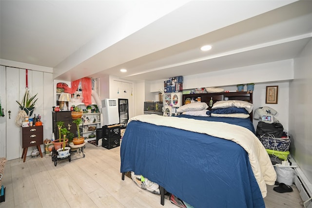 bedroom with light wood finished floors and recessed lighting