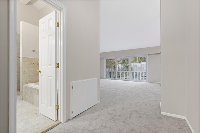 corridor featuring carpet flooring and baseboards