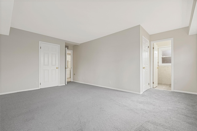 spare room with carpet floors and baseboards