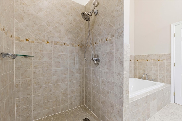 full bath featuring a garden tub and tiled shower