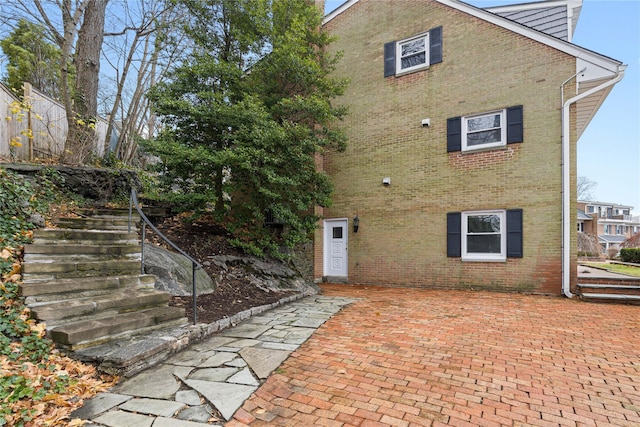 rear view of property featuring brick siding